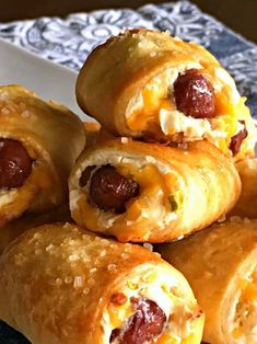 several sausage wrapped in bread on a plate