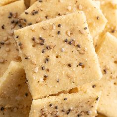 sesame seed crackers stacked on top of each other with seeds all over the edges