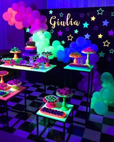 there are many desserts on the tables in this room with balloons and stars around them