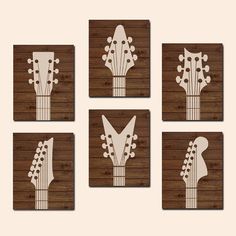 four guitar heads mounted on wooden plaques