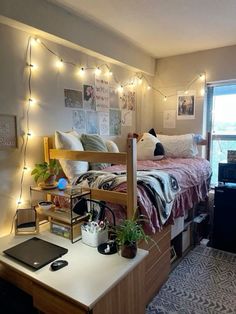 a bed room with a neatly made bed and lots of lights on the wall above it