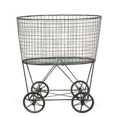 a metal wire basket with wheels on a white background