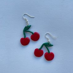 These polymer clay earrings feature red cherries! **Please note that these earrings are handmade and each pair may differ slightly Trendy Red Resin Earrings, Handmade Trendy Cherry Earrings, Trendy Handmade Cherry Colored Earrings, Trendy Handmade Cherry Earrings, Red Drop Earrings In Polymer Clay, Playful Nickel-free Red Earrings, Handmade Cherry Cute Earrings, Handmade Cute Cherry Earrings, Playful Handmade Red Earrings