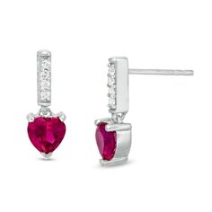 She'll be enamored at the sight of these darling drop earrings. Fashioned in sterling silver, this adorable look showcases a 5.0mm heart-shaped lab-created bright red ruby beneath a white sapphire-lined linear post. Buffed to a brilliant luster, these post earrings secure comfortably with friction backs. This ring is custom-made to fit your ring size. Sterling silver rings cannot be resized after purchase. Valentine's Day Fine Jewelry Heart Dangle Earrings, Valentine's Day Classic Dangle Earrings, Classic Dangle Earrings For Valentine's Day, Classic Valentine's Day Dangle Earrings, Skull Jewelry Women, Buy Earrings Online, Tiffany And Co Necklace, Peoples Jewellers, Buy Earrings