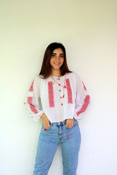 "Vintage Romanian handmade/ hand-embroidered blouse in white embroidery in red, neckline, and sleeves with a red cord with tassels, gauze cotton, somewhat sheer.  aside from minor signs of wear, good vintage condition clean ready to wear.  The model is 5'7\" and size S for reference Approximate size: S/M/L - Please refer to the measurements. M E A S U R E M E N T S -were taken with garments laying flat, please double where necessary. ------------------------♥-------- Bust:22\"-56cm Length:19\"-4 Red Blouse With Embroidered Border, Folk Style Embroidered Red Peasant Top, Red Embroidered Folk Peasant Top, Handmade Long Sleeve Spring Blouse, Red Folk Style Long Sleeve Peasant Top, Red Long Sleeve Folk Peasant Top, Red Embroidered Folk Blouse, Folk Style Red Blouse For Festivals, Handmade White Folk Style Top