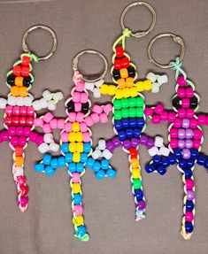 three key chains with different colored beads on them