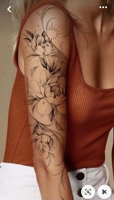 a woman with a flower tattoo on her arm