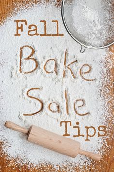 the word bake sale written in flour next to a rolling pin