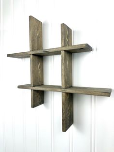 three wooden shelves mounted to the side of a wall