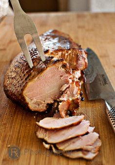 a piece of meat on a cutting board with a knife