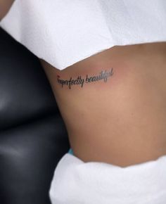 a woman with a tattoo on her stomach that reads imperfectity beautiful