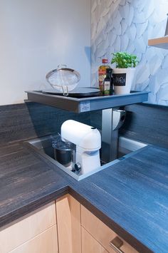 a kitchen counter with a coffee maker in it