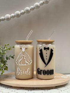 two mason jars decorated with bride and groom's names