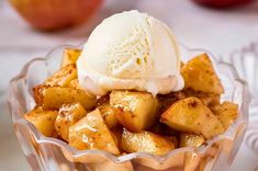 an apple dessert with ice cream in a glass bowl