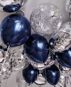 blue and silver balloons are on display at a party