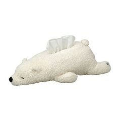 a stuffed polar bear laying on its side with a tissue roll in it's mouth