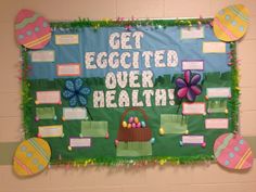 a bulletin board with eggs and flowers on it