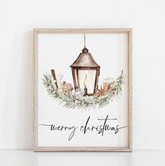 a watercolor christmas card with a lantern and greenery on the front, which reads merry christmas