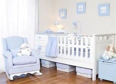 a baby's room with blue and white furniture