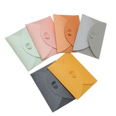 five different colored envelopes with holes in them