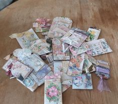 a pile of old money sitting on top of a wooden table