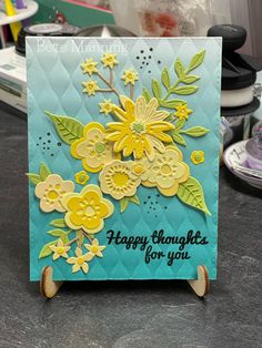 a close up of a greeting card on a table with other items in the background