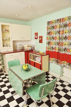 an image of a kitchen with green chairs and black and white checkered flooring