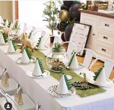 the table is set with white and green decorations