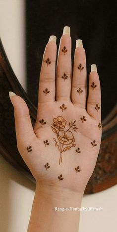 a woman's hand with flowers painted on it