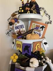 a white tower with halloween decorations and cards on it's sides, in front of a wall