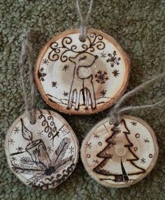 three wooden ornaments are hanging from twine on the carpet, with string attached to each ornament