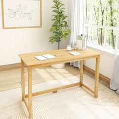 a wooden desk sitting in front of a window next to a potted green plant