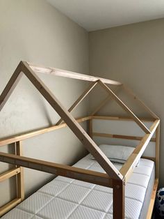 the bed frame is made out of wood and has no mattresses on top of it