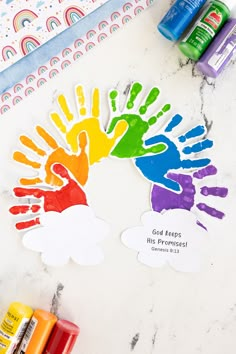 colorful handprints on a table with crayons and markers