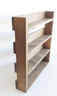 a book shelf made out of wood on a white surface with no one in it