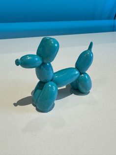 a blue balloon dog sitting on top of a table