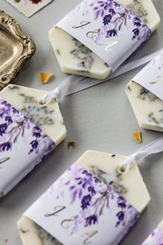 some soaps with flowers on them sitting next to a tray