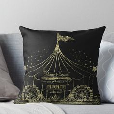 a black and gold throw pillow sitting on top of a couch