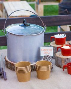 a table topped with lots of pots and pans filled with food on top of it