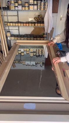 a woman standing in front of a display case