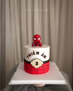 a spiderman themed birthday cake on top of a table