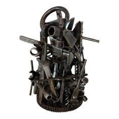 a sculpture made out of various tools and wrenches on top of eachother