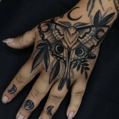 a woman's hand with tattoos on it and an owl tattoo on the palm