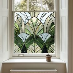 a stained glass window with a potted plant in it