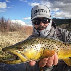 a man holding a large fish in his hand