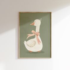 a white duck with a pink bow on it's head sitting in front of a wall