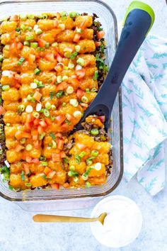 a casserole dish with carrots, onions and peas