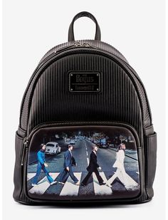 a black backpack with the beatles on it's front and side panels, featuring an image of people walking across a crosswalk