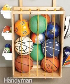 a wooden crate filled with lots of different colored balls