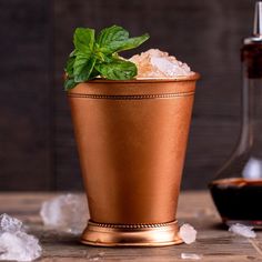 a copper cup filled with ice and mint